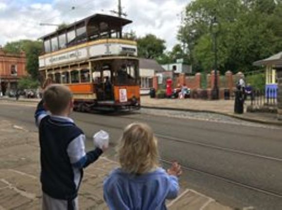 Children waving at tram driver