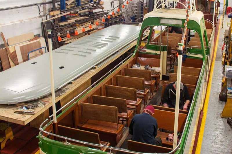 Volunteers working on a tram in the workshop